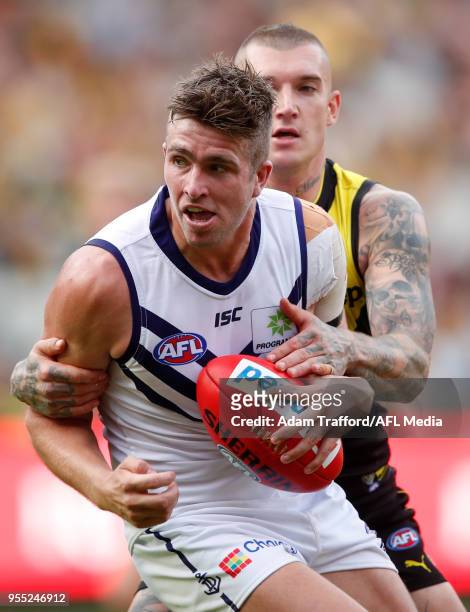 Luke Ryan of the Dockers is tackled by Dustin Martin of the Tigers during the 2018 AFL round seven match between the Richmond Tigers and the...