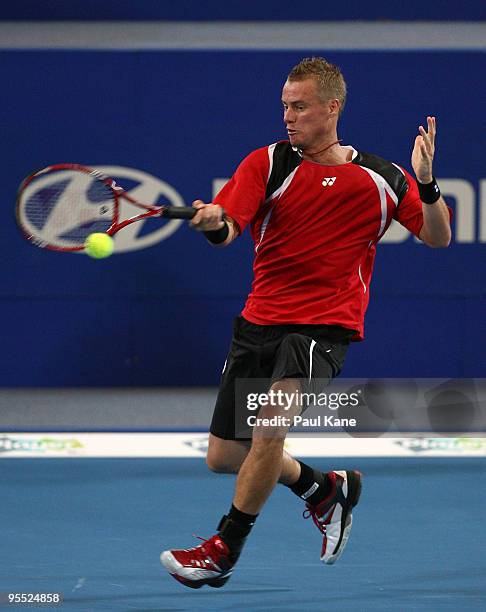 Lleyton Hewitt of Australia plays a forehand in his match against Victor Hanescu of Romania in the Group A match between Australia and Romania during...