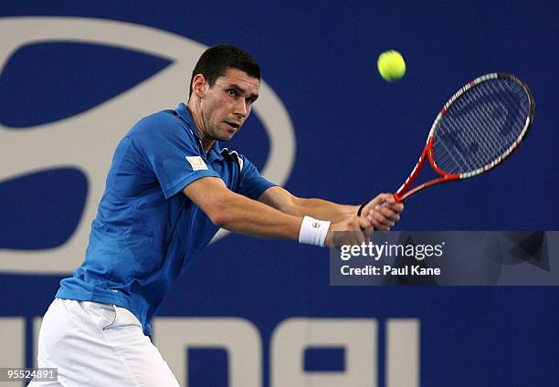 Victor Hanescu of Romania plays a backhand in his match against Lleyton Hewitt of Australia in the Group A match between Australia and Romania during...