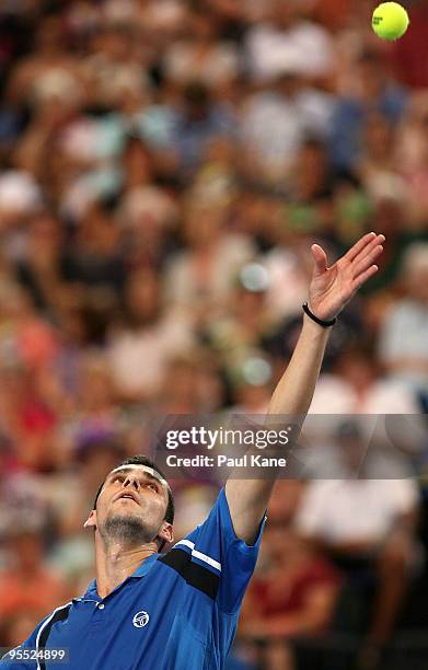 Victor Hanescu of Romania serves in his match against Lleyton Hewitt of Australia in the Group A match between Australia and Romania during day one...