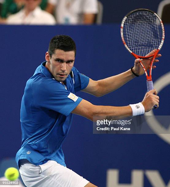 Victor Hanescu of Romania plays a backhand in his match against Lleyton Hewitt of Australia in the Group A match between Australia and Romania during...