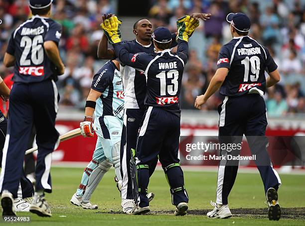 Dwayne Bravo of the Bushrangers celebrates with Matthew Wade after combining to dismiss David Warner of the Blues during the Twenty20 Big Bash match...