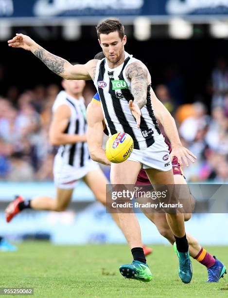 Jeremy Howe of Collingwood kicks the ball during the round seven AFL match between the Brisbane Lions and the Collingwood Magpies at The Gabba on May...