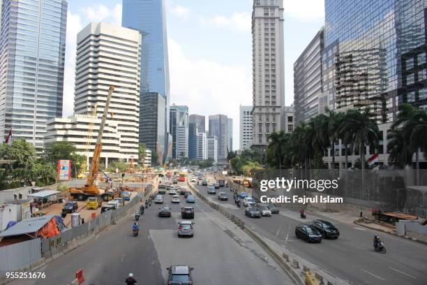 traffic in sudirman street, jakarta - sudirman stock pictures, royalty-free photos & images