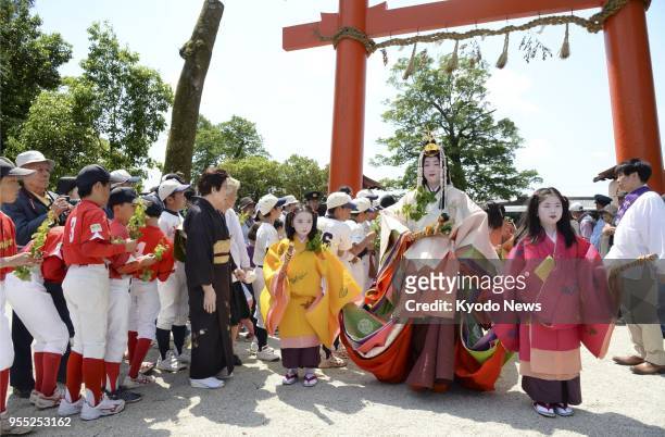 Shiho Sakashita , clad in a 12-layer traditional Japanese kimono, arrives at Kamigamo Jinja, a Shinto shrine in Kyoto, for a ritual on May 4 prior to...
