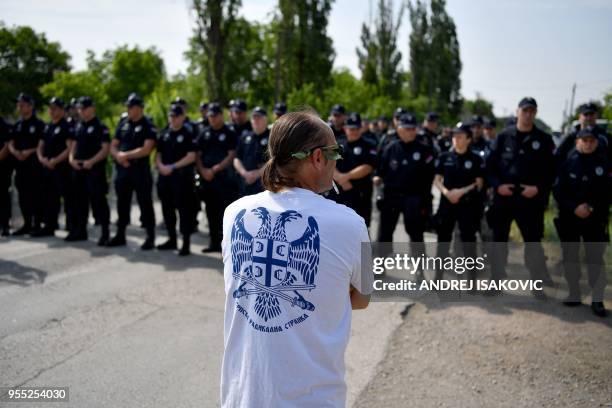 Supporter of Serbian Radical Party leader Vojislav Seselj stands in the village of Jarak near Hrtkovci on May 6, 2018 in front of a police cordon...