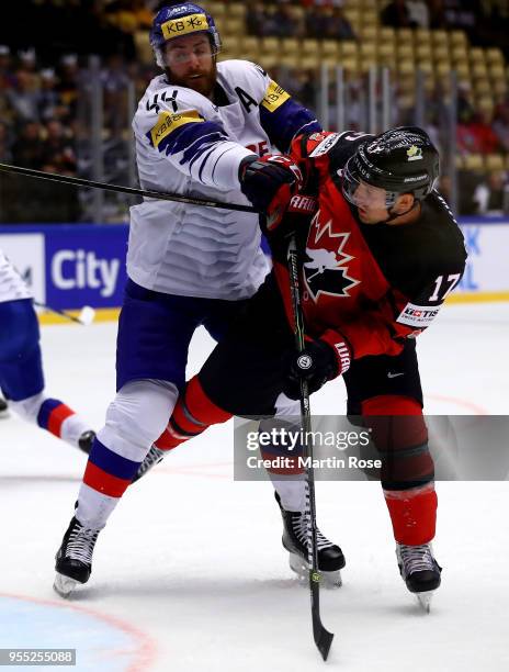 Alex Plante of Korea and Jaden Schwartz of Canada battle for the puck during the 2018 IIHF Ice Hockey World Championship group stage game between...