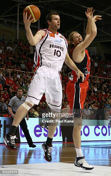 Luke Schenscher of the Wildcats and Larry Davidson of the Hawks contest a rebound during the round 14 NBL match between the Perth Wildcats and the...