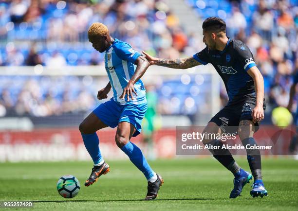 Brown Aide Ideye of Malaga competes for the ball with Guillermo Maripan of Deportivo Alaves during the La Liga match between Malaga and Deportivo...
