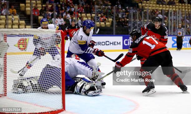 Hyonho Oh of Korea and Jaden Schwartz of Canada battle for the puck during the 2018 IIHF Ice Hockey World Championship group stage game between Korea...