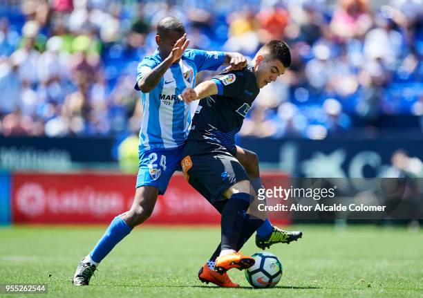 Diego Rolan of Malaga competes for the ball with Martin Aguirregabiria of Deportivo Alaves during the La Liga match between Malaga and Deportivo...