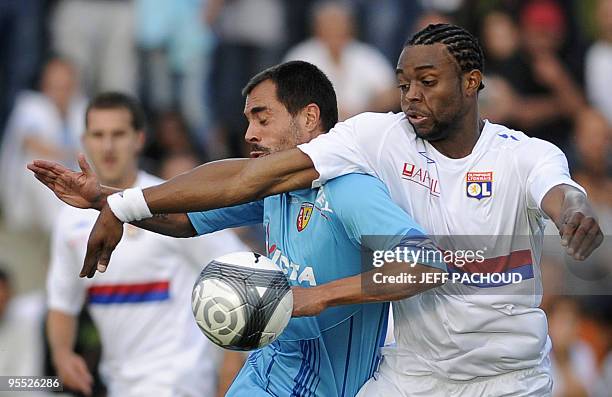 Lens' Portugese defender Marco Ramos fights for the ball with Lyon's French forward Frederic Piquione , on July 18 during their friendly French...