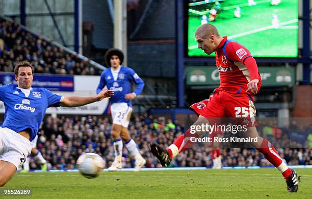 Adam Clayton of Carlisle shoots to score his team's first goal, deflected in by teammate Kevan Hurst during the third round match of The FA Cup,...