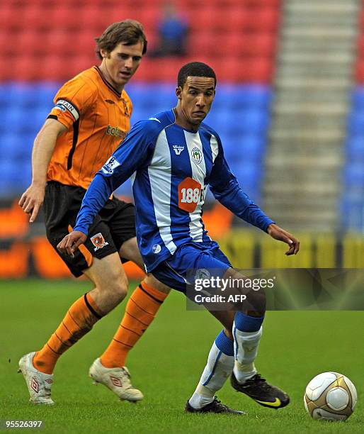 Wigan Athletic's English forward Scott Sinclair vies with Hull City's Irish midfielder Kevin Kilbane during the FA Cup third round football match...