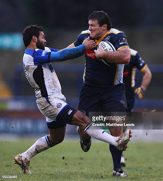 Mike Macdonald of Leeds is tackled by Joe Maddock of Bath during the Guinness Premiership match between Leeds Carnegie and Bath at Headingley Stadium...