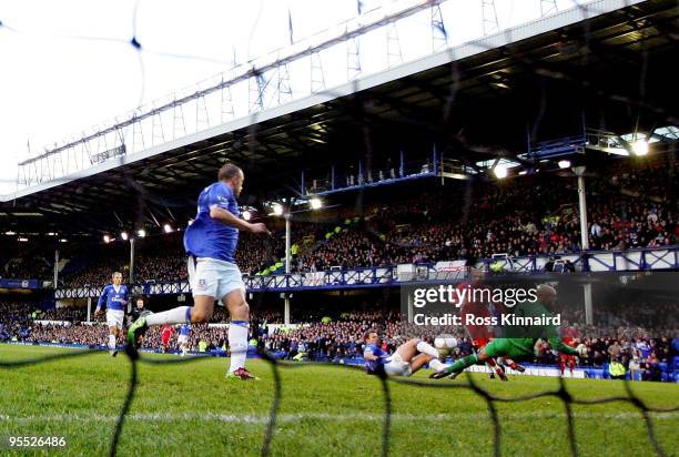 Adam Clayton of Carlisle shoots to score his team's first goal past Everton goalkeeper Tim Howard, deflected in by teammate Kevan Hurst during the...