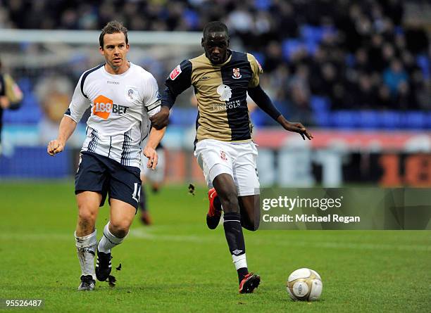 Kevin Davies of Bolton takes on Moses Swaibu of Lincoln during the FA Cup 3rd Round match between Bolton Wanderers v Lincoln City at the Reebok...