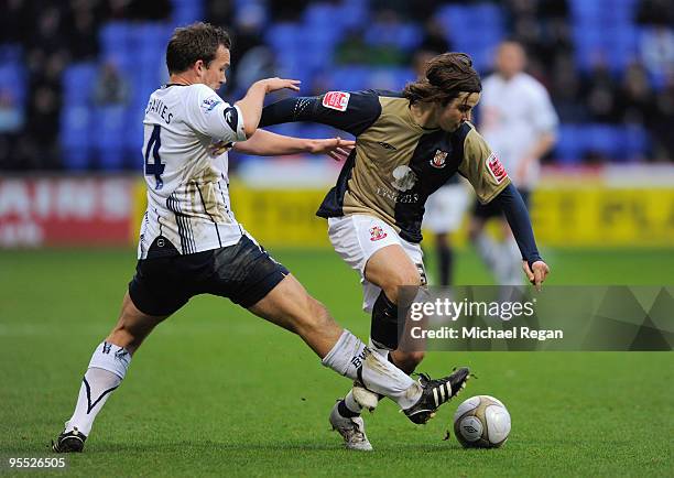 Kevin Davies of Bolton challenges Chris Herd of Lincoln during the FA Cup 3rd Round match between Bolton Wanderers v Lincoln City at the Reebok...