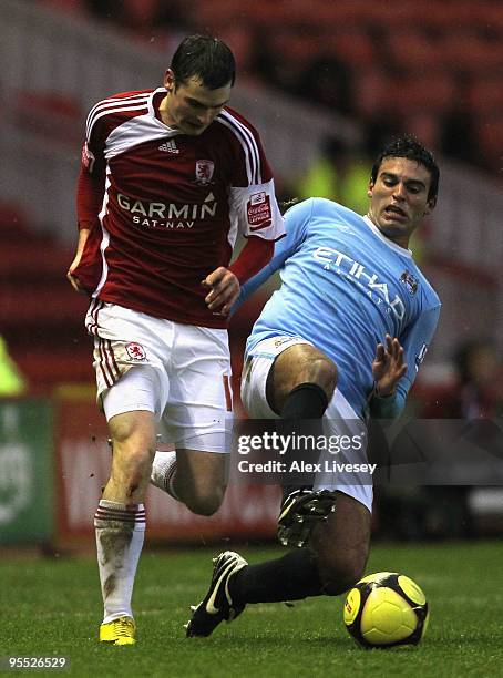 Javier Garrido of Manchester City tackles Adam Johnson of Middlesbrough during the FA Cup sponsored by E.ON 3rd Round match between Middlesbrough and...