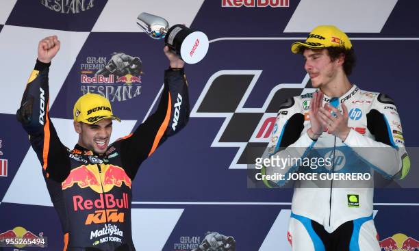Second placed Leopard Racing's Portuguese rider Miguel Oliveira celebrates on the podium beside first placed Forward Team's Italian rider Lorenzo...
