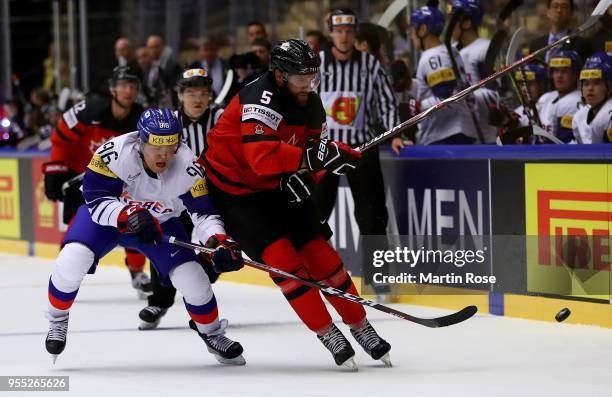 Sangwoo Shin of Korea and Aaron Ekblad of Canada battle for the puck during the 2018 IIHF Ice Hockey World Championship group stage game between...