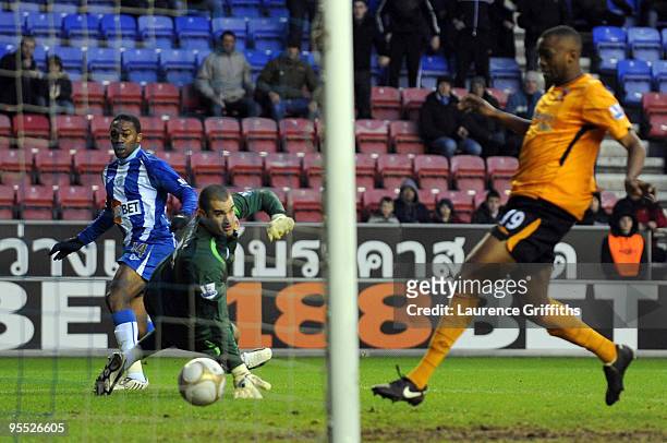 Charles N'Zogbia of Wigan scores the equaliser past Boaz Myhill of Hull during the The FA Cup sponsored by E.ON Third Round match between Wigan...