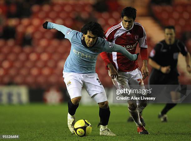 Carlos Tevez of Manchester City holds off the challenge of Adam Johnson of Middlesbrough during the FA Cup sponsored by E.ON 3rd Round match between...