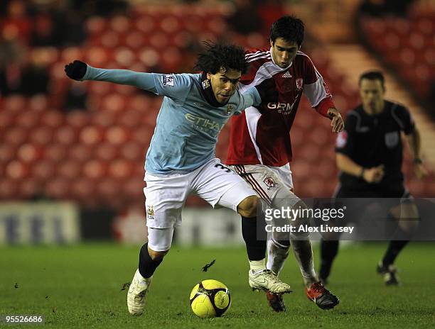 Carlos Tevez of Manchester City holds off the challenge of Adam Johnson of Middlesbrough during the FA Cup sponsored by E.ON 3rd Round match between...