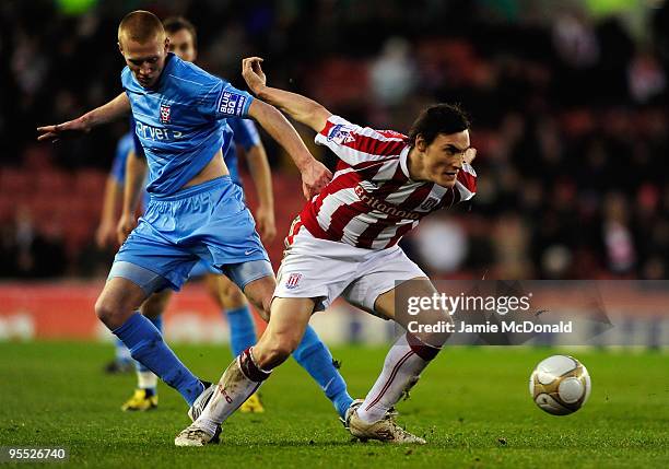 Levi Mackin of York City battles with Dean Whitehead of Stoke City during the FA Cup sponsored by E.ON 3rd Round match between Stoke City and York...