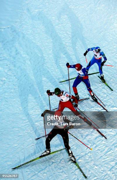 Eric Frenzel of Germany competes infront of Wilhelm Denifl of Austria, Bernhard Gruber of Austria and Janne Ryynaenen of Finnland during the Cross...