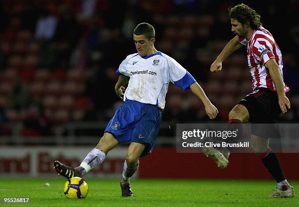 Andy Bond of Barrow AFC in action against Lorik Cana of Sunderland during the FA Cup sponsored by E.ON 3rd Round match between Sunderland and Barrow...