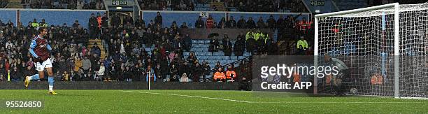Aston Villa's Norwegian forward John Carew scores a penalty past Blackburn Rovers' Welsh goalkeeper Jason Brown during the FA Cup third round...