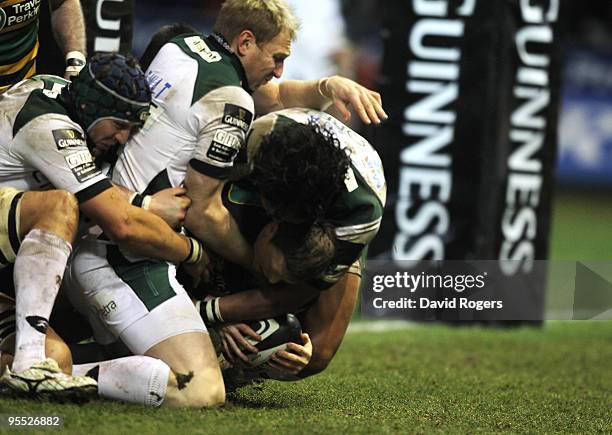 Chris Ashton of Northampton, despite being held by the London Irish defence, dives over to score a last minute try during the Guinness Premiership...