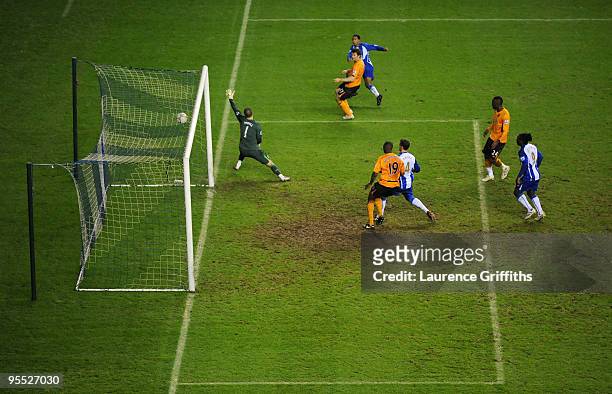 Scott Sinclair of Wigan scores the 4:1 goal past goalkeeper Boaz Myhill of Hull during the The FA Cup sponsored by E.ON Third Round match between...