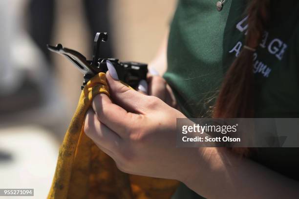 Sophomore Ashlynn Brock of the Osage High School trap team cleans her shotgun following a match at the Mitchell County Trap Range on May 5, 2018 in...