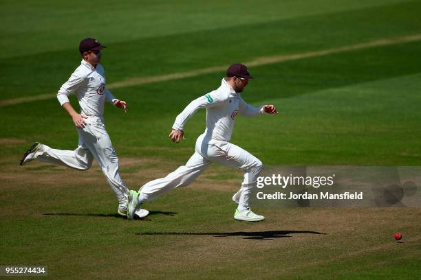 Mark Stoneman and Ollie Pope of Surrey chase down a ball during day three of the Specsavers County Championship Division One match between Surrey and...