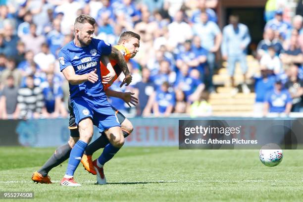 Joe Ralls of Cardiff City battles with Jon Dadi Bodvarsson of Reading during the Sky Bet Championship match between Cardiff City and Reading at The...