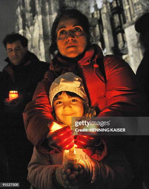Protestors hold a candle-light vigil to commemorate the victims of recent demonstrations in Iran on January 2, 2010 in the central German city of...