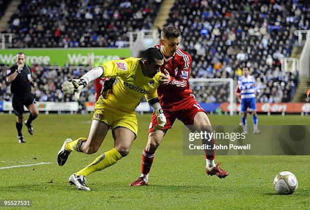 Fabio Aurelio of Liverpool battles with Adam Federici goalkeeper of Reading during the FA Cup 3rd round match between Reading and Liverpool at the...