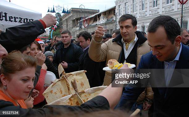Georgian President Mikheil Saakashvili meets the crowd to celebrate New Year holidays in Batumi on January 2, 2010. AFP PHOTO / SEIRAN BAROYAN