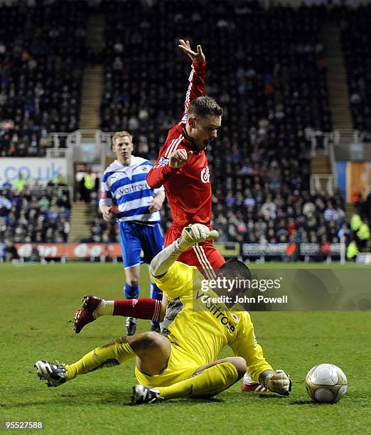 Fabio Aurelio of Liverpool battles with Adam Federici goal keeper of Reading during the FA Cup 3rd round match between Reading and Liverpool at the...