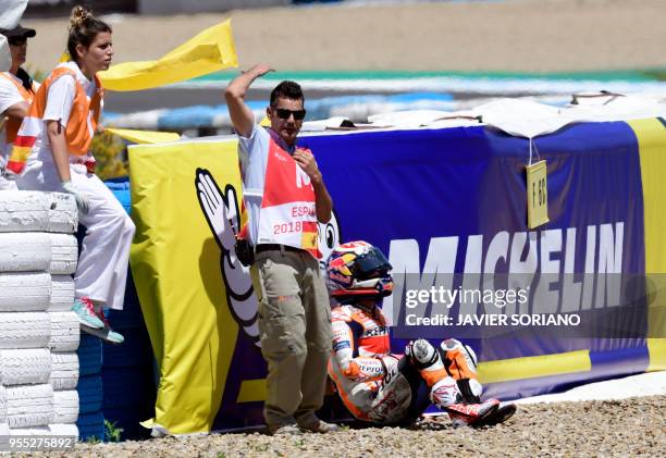 Repsol Honda Team's Spanish rider Dani Pedrosa sits after falling down during the MotoGP race of the Spanish Grand Prix at the Jerez Angel Nieto...