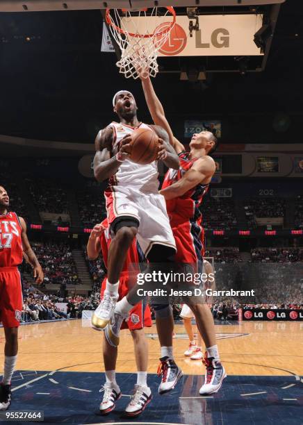 LeBron James of the Cleveland Cavaliers shoots against Yi Jianlian of the New Jersey Nets during the game on January 2, 2010 at the Izod Center in...