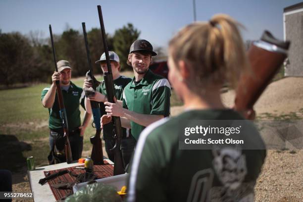 Members of the Osage High School trap team clean their shotguns following a match at the Mitchell County Trap Range on May 5, 2018 in Osage, Iowa....