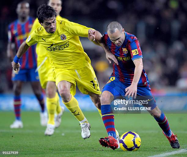 Barcelona's midfielder Andres Iniesta vies with Villarreal's defender Javi Venta during their Spanish football League match on January 2, 2010 at...