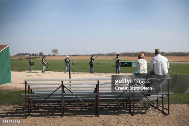 Members of the Osage High School trap team compete in a match at the Mitchell County Trap Range on May 5, 2018 in Osage, Iowa. The Osage team, which...