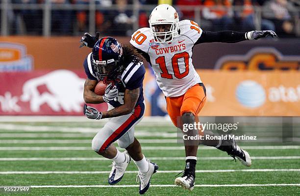 Dexter McCluster of the Mississippi Rebels runs the ball against Markelle Martin of the Oklahoma State Cowboys during the AT&T Cotton Bowl on January...