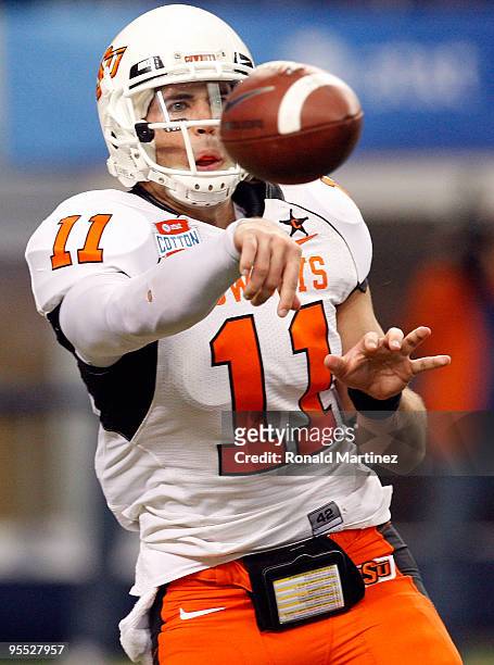 Quarterback Zac Robinson of the Oklahoma State Cowboys passes against the Mississippi Rebels during the AT&T Cotton Bowl on January 2, 2010 at...