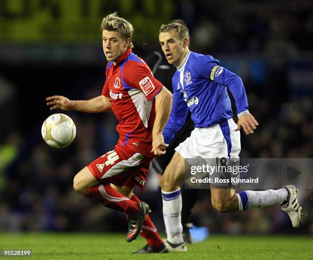 Kevin Hurst of Carlisle is challenged by Phil Neville of Everton during the third round match of The FA Cup, sponsored by E.ON, between Everton and...