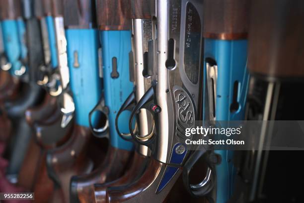 Shotguns used by members of the Osage High School trap team sit in a trailer during a match at the Mitchell County Trap Range on May 5, 2018 in...